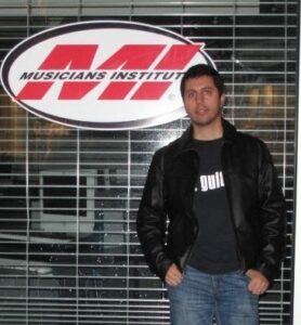 Vin in front of MI school logo